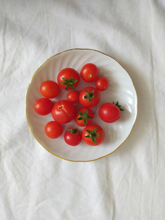tomatoes are placed in the center of a white plate