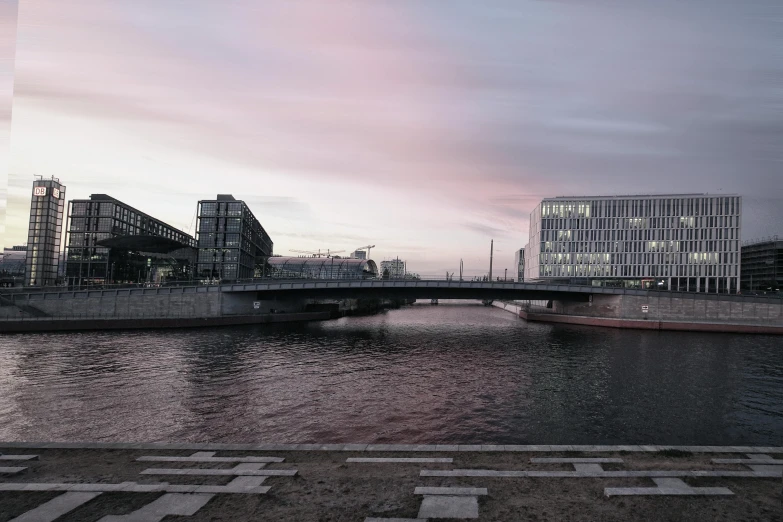 a river with some buildings and a bridge