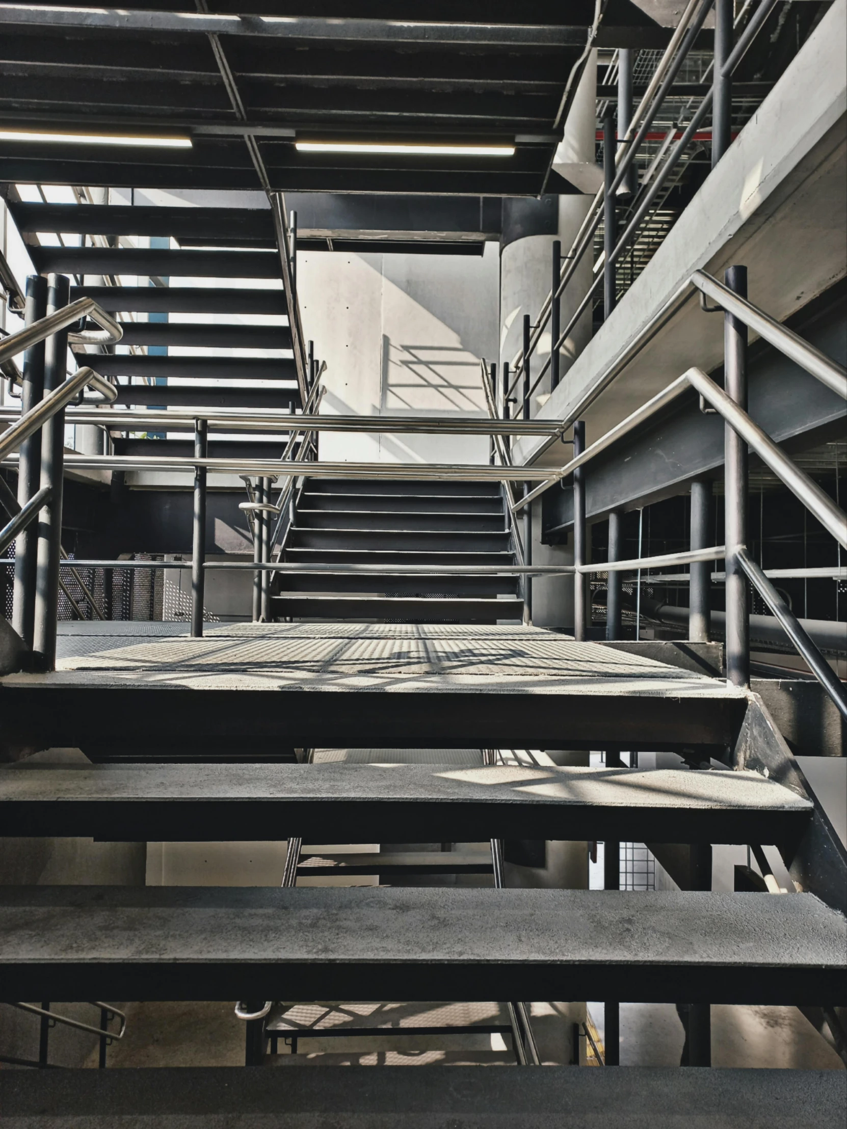 a bunch of empty benches next to a stairwell