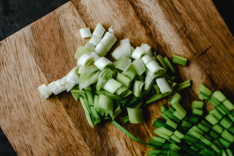 chopped vegetables are ready to be diced onto a  board