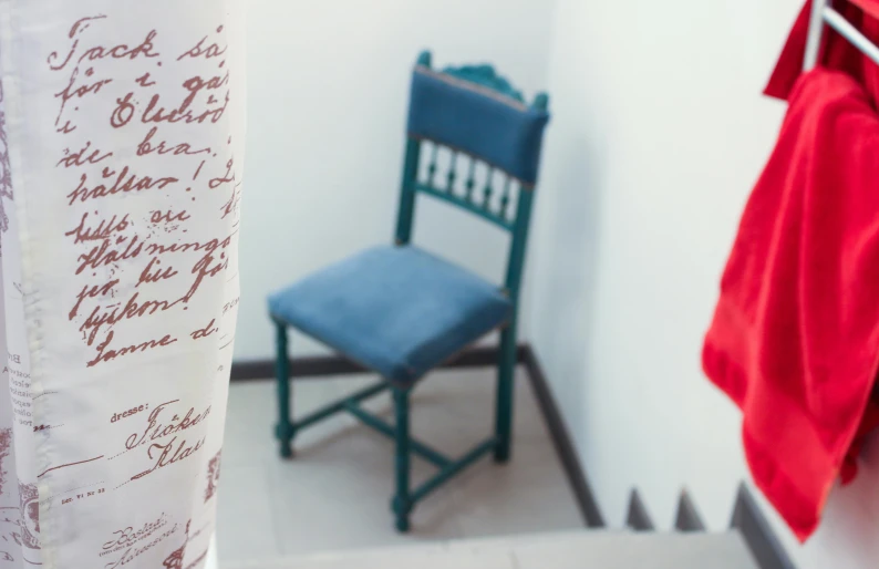 a small blue chair sits beside a small red chair
