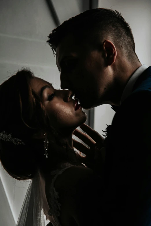 the bride is kissing the groom on the cheek