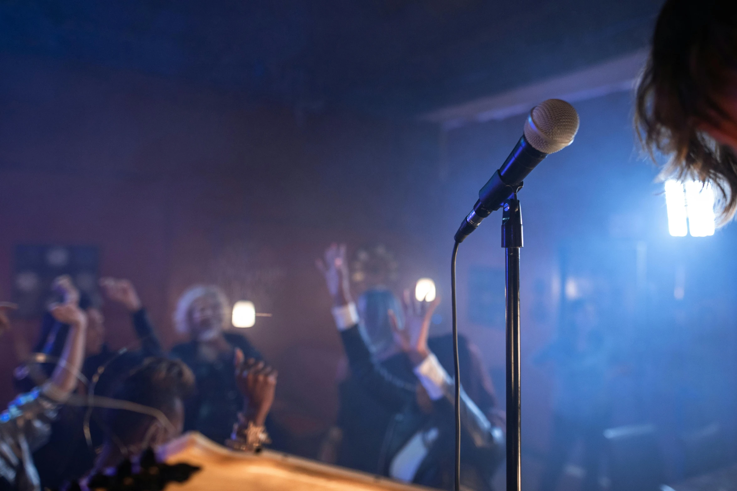 microphone on stage with hand gesture in front