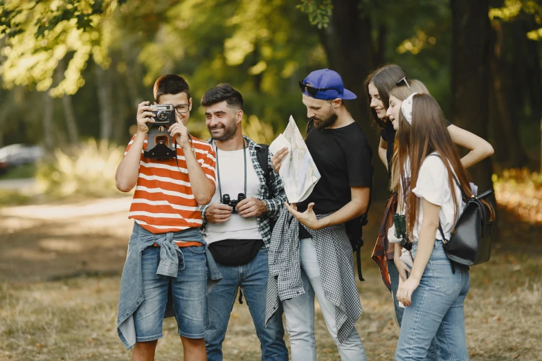 three people are posing for a po with their camera