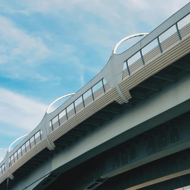 a bridge with white railings and a traffic sign