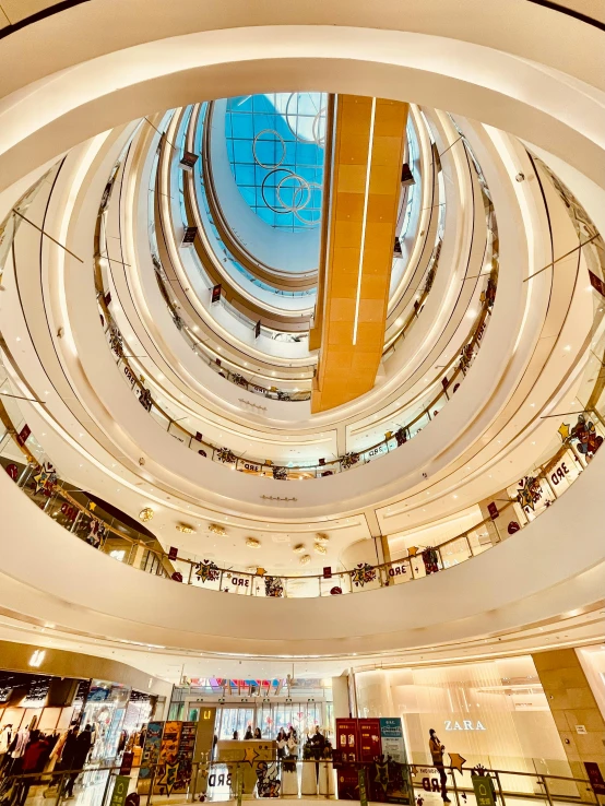 a view inside a huge building of people shopping