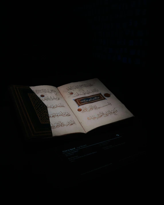 a lit book in the dark is open