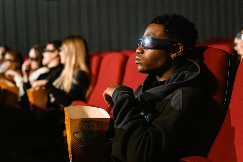 people in a movie theater sitting in the dark