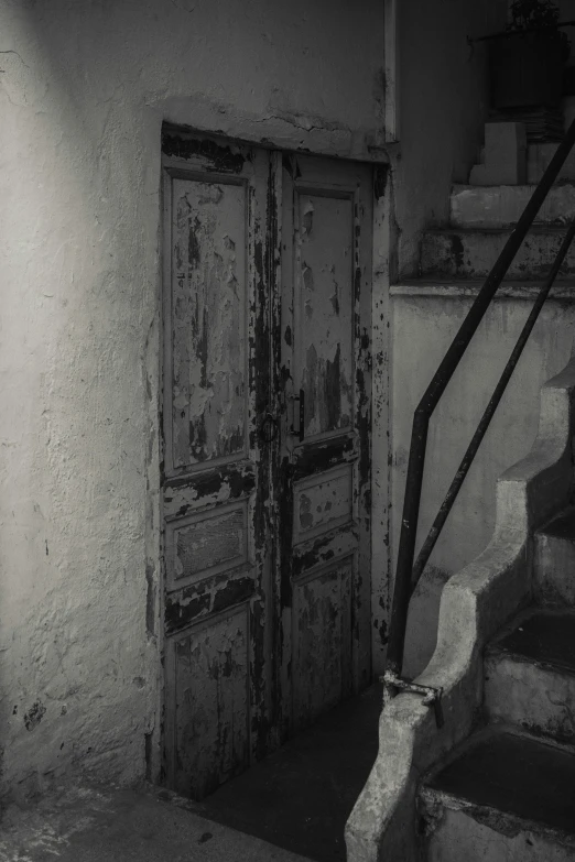 a pair of stairs leading up to a wooden door