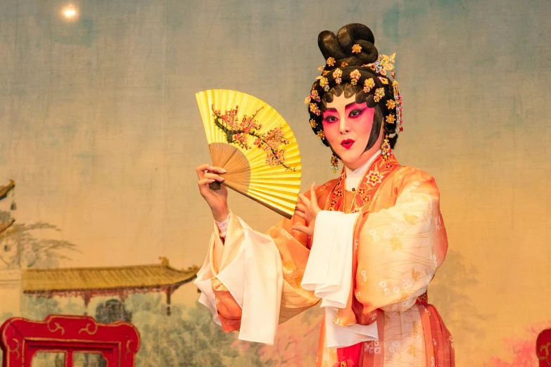 a woman in a geisha costume holding a fan