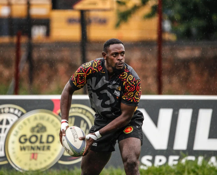 a rugby player holding the ball in his hands