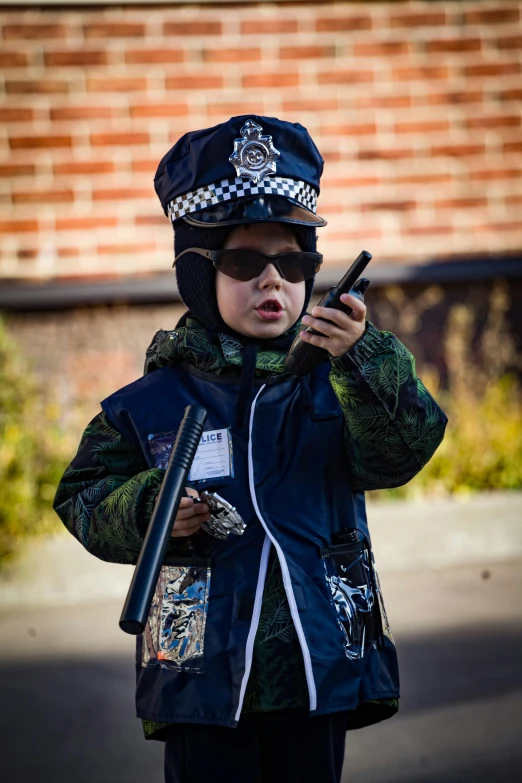 the  wearing glasses is wearing a helmet while looking at his phone