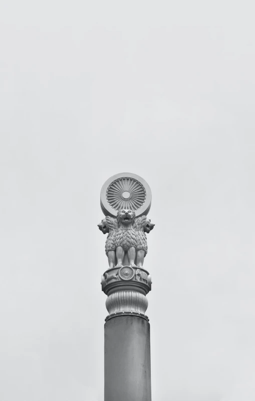 a decorative pillar and its sculpture stands tall