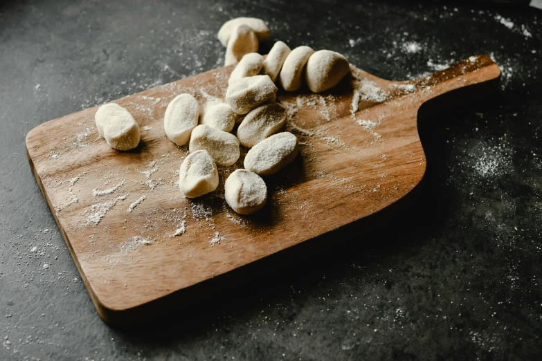 a wooden board topped with diced up food