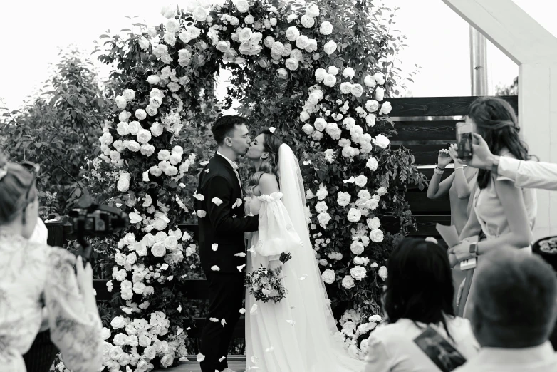 a couple getting married while others are watching