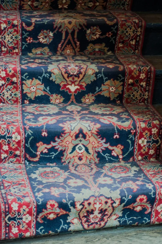 several oriental rugs on top of some stairs