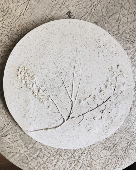 a plant shaped dish that has a plate of food on it