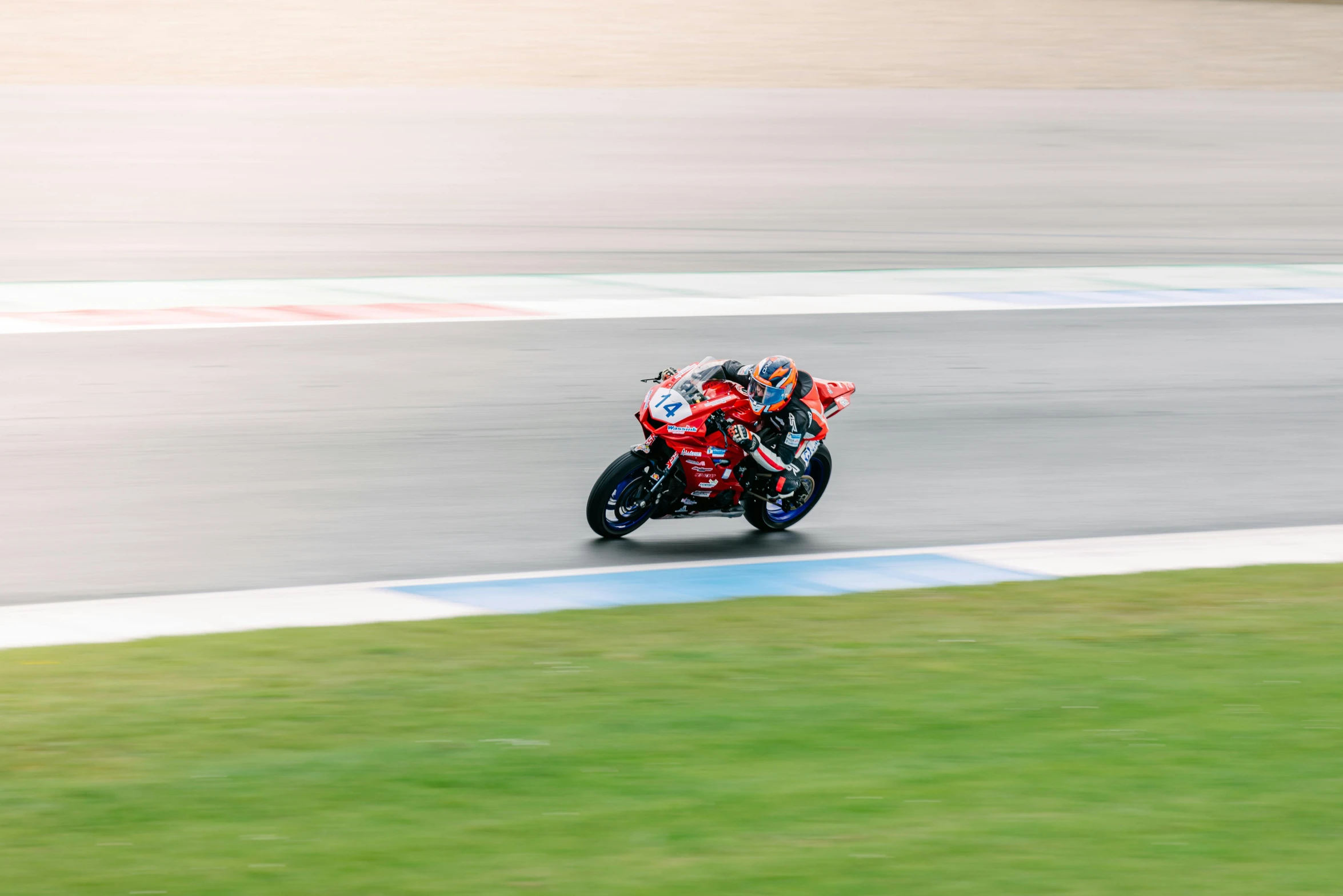 a motorcycle rider in motion on a track