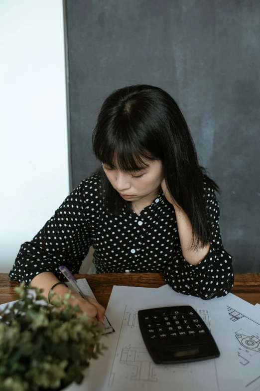 an image of a woman doing homework at home