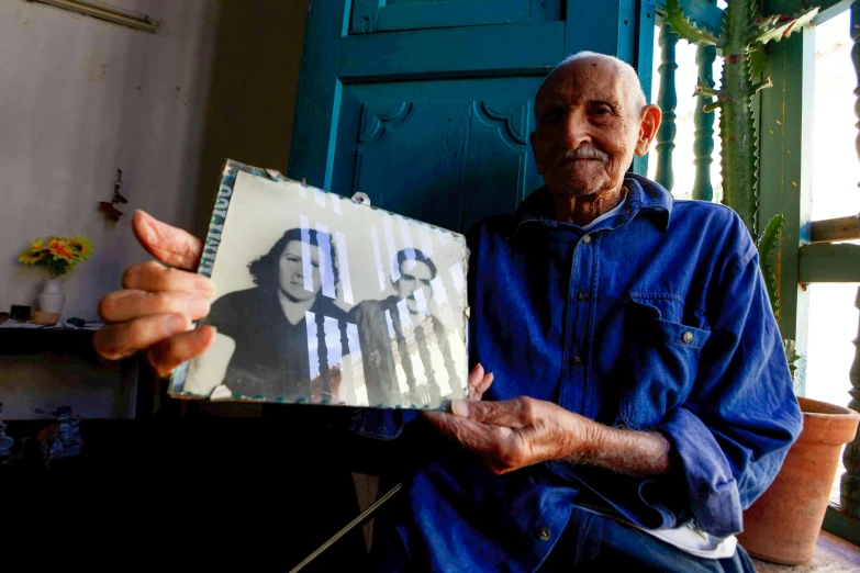 a man that is sitting in front of a window