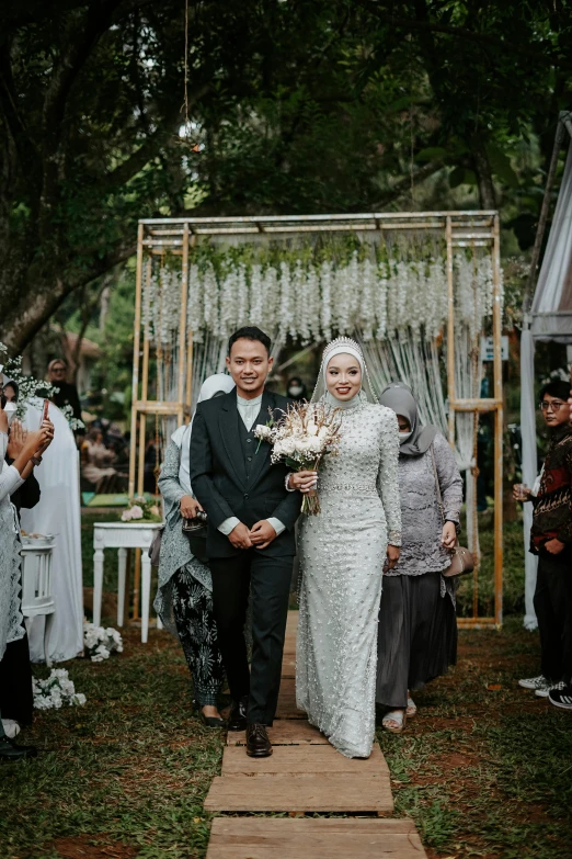 the bride and groom walk down the aisle to their wedding ceremony