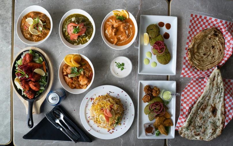 a table topped with bowls and dishes filled with food