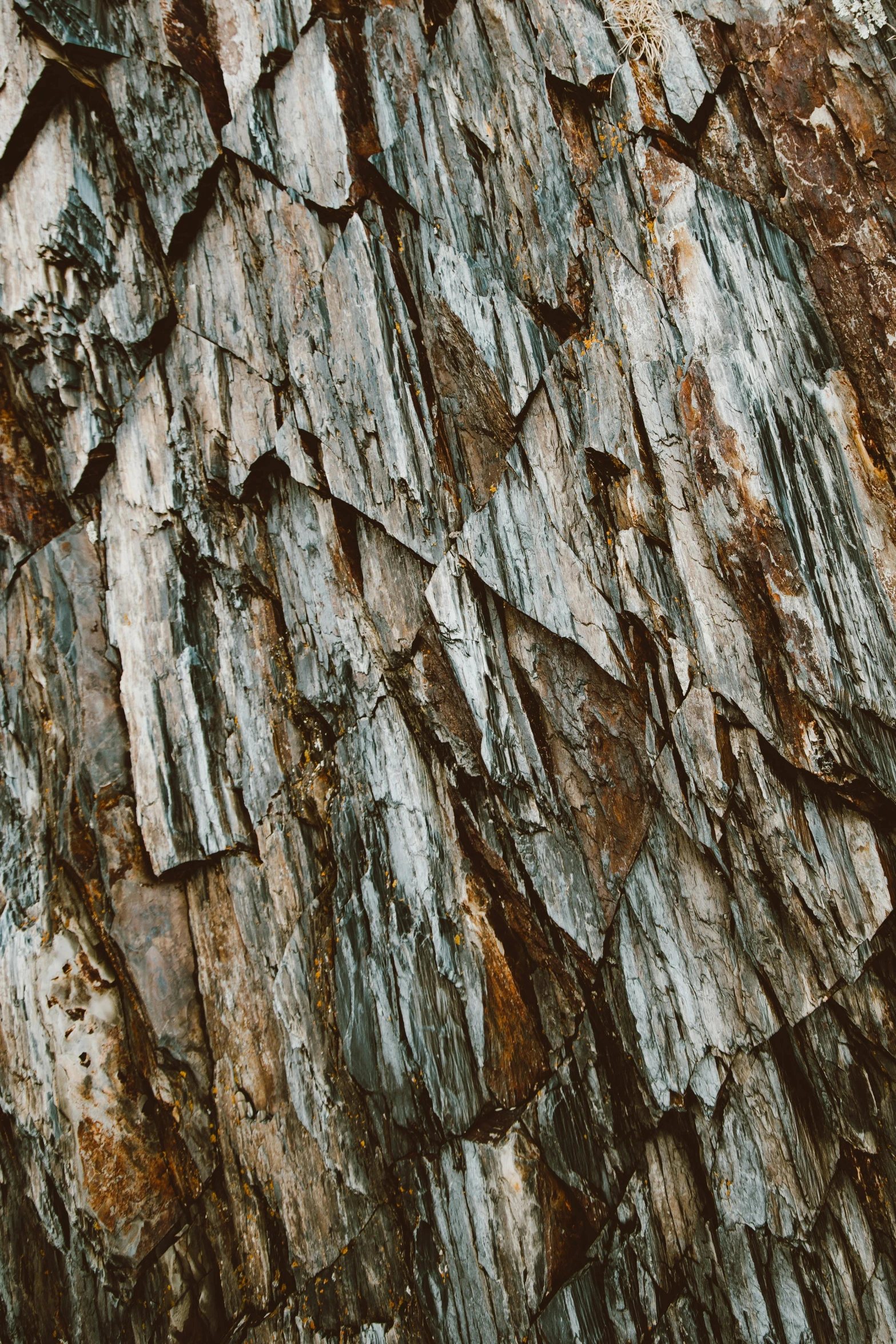 a rock wall with very little wood on top