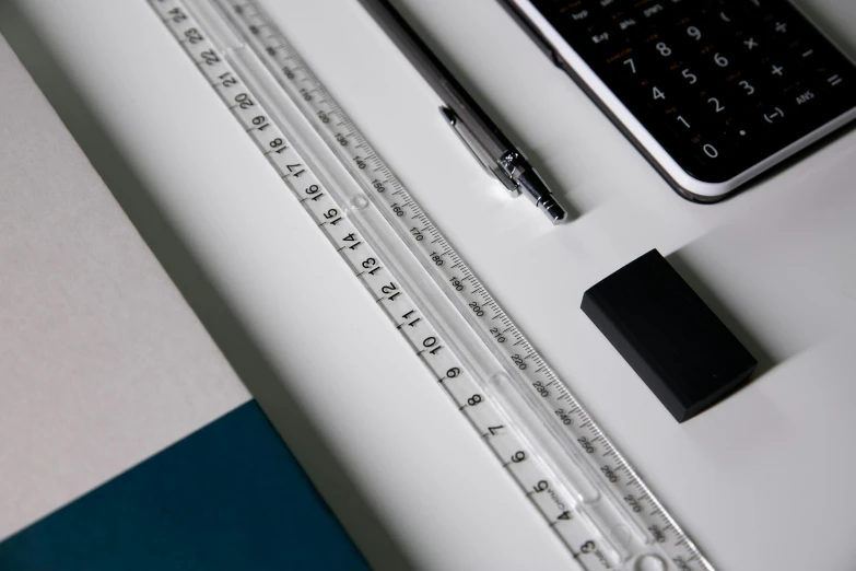 ruler, pen and cell phone on desk