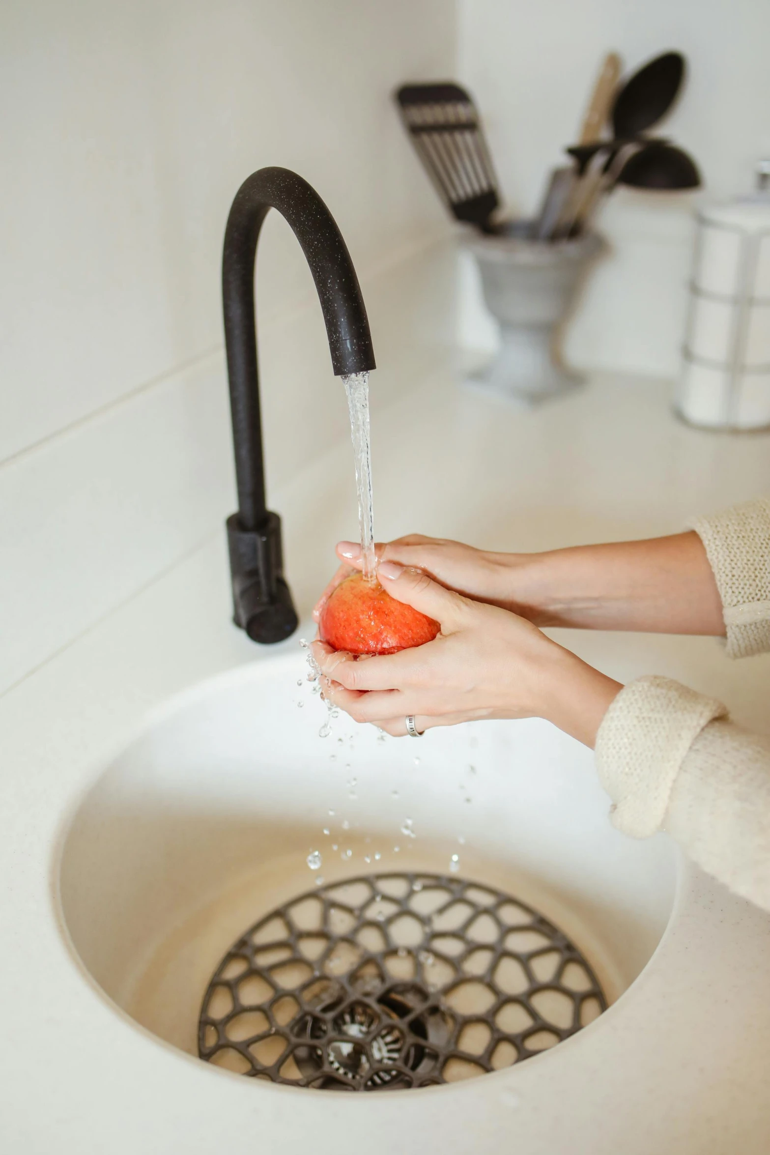 the woman is washing vegetables in the sink