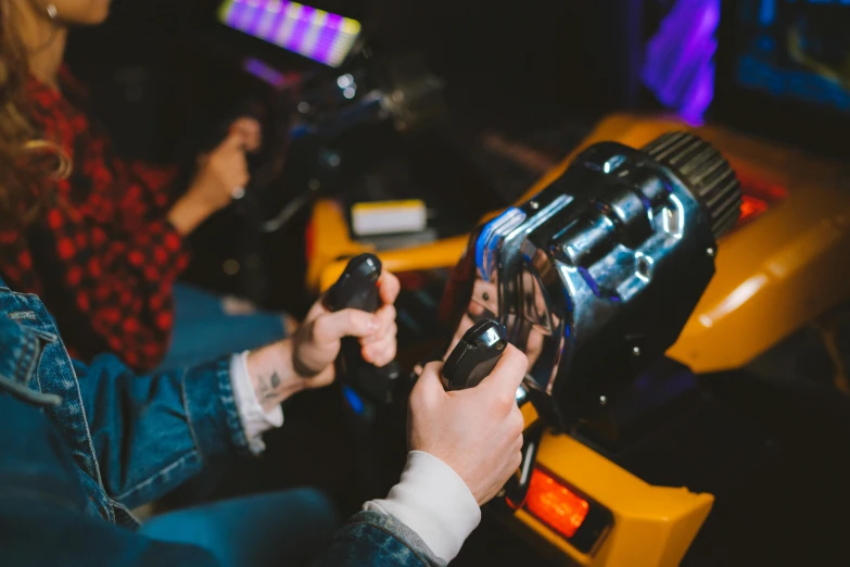 the woman is holding a remote control while playing the game on the arcade