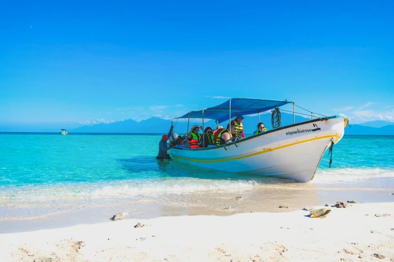 several people are in a boat in the ocean