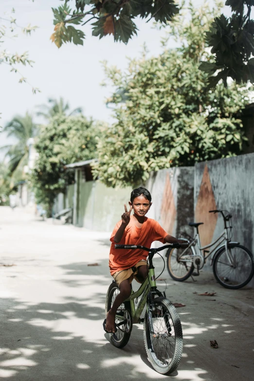 a man riding a green bicycle on top of a road