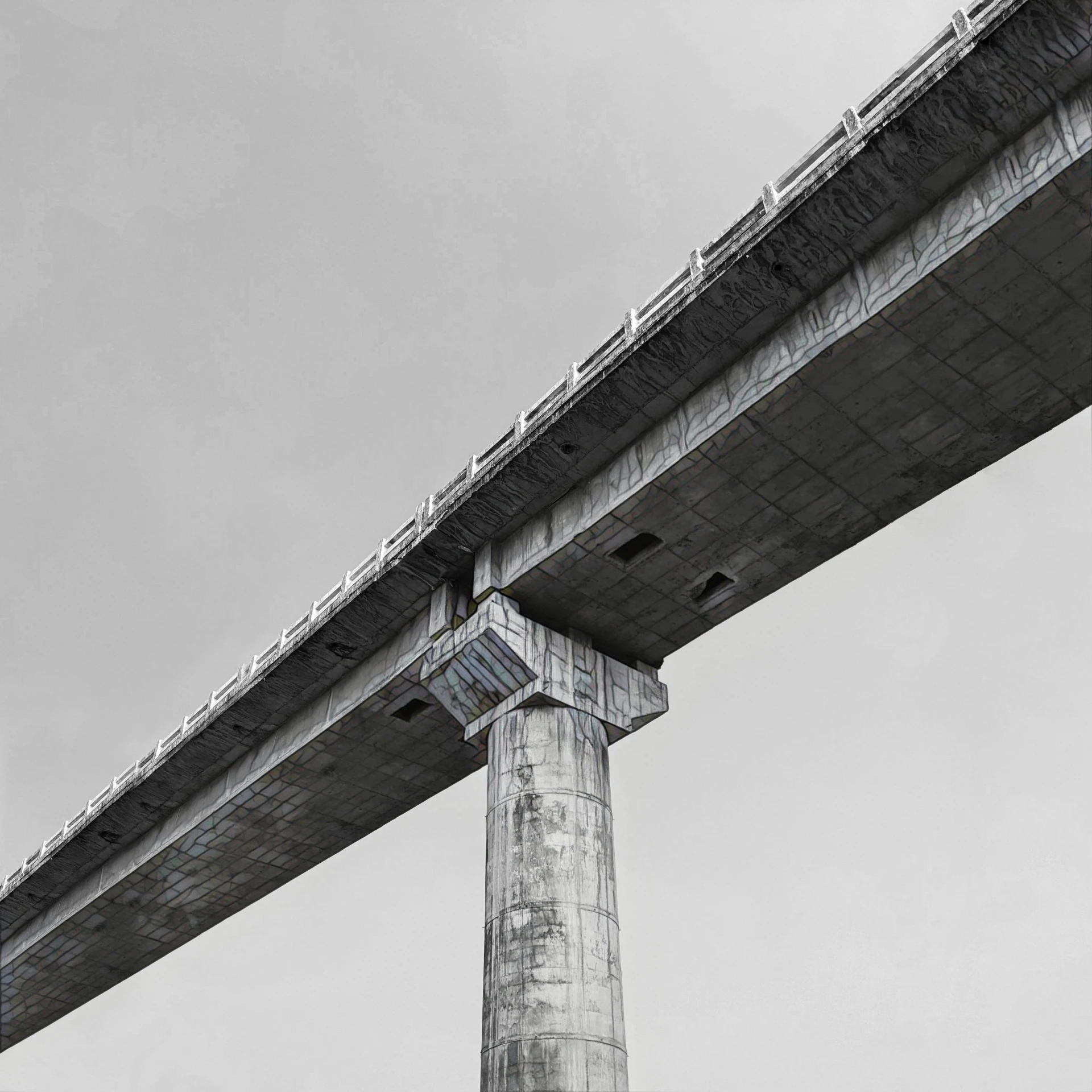 the bottom of a large bridge spanning the width of a bridge