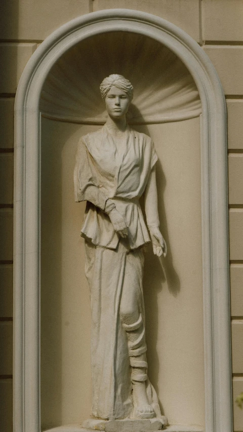 a statue with a sculptural frame and a window