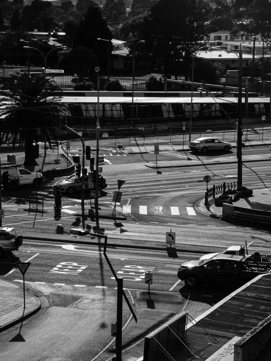 a busy intersection with a train on the tracks