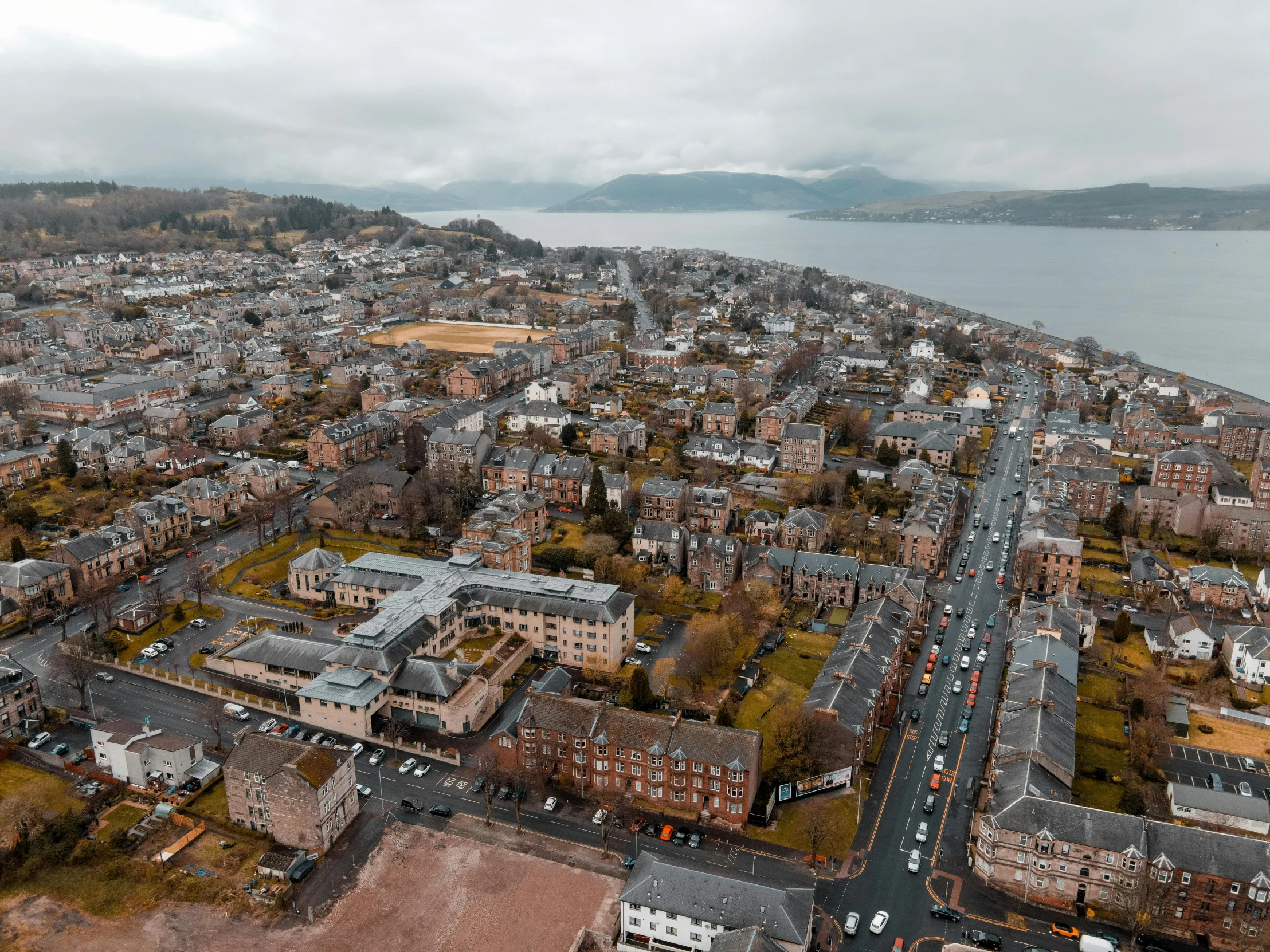 an overhead view of the city area, with water in the background