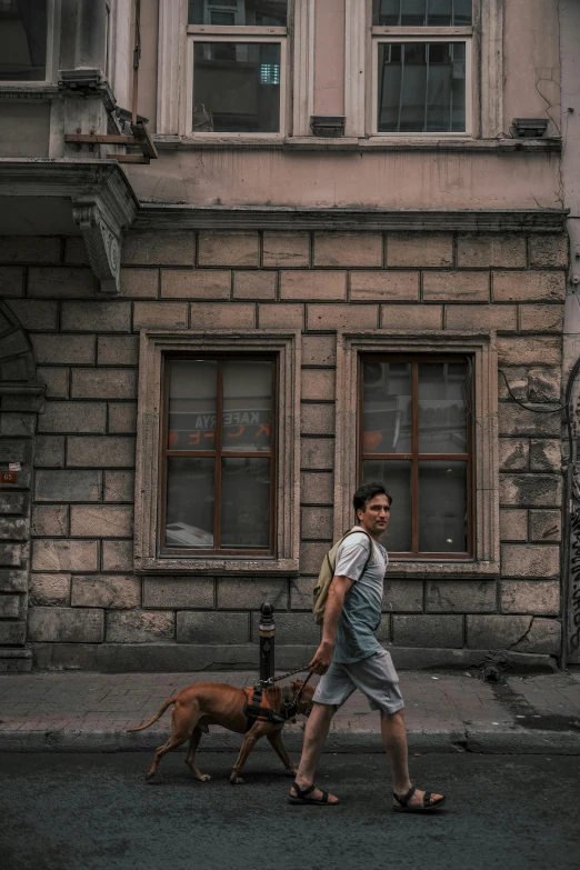 a man walking his dog down the street