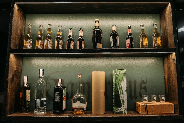 liquor bottles on a shelf in front of a wall