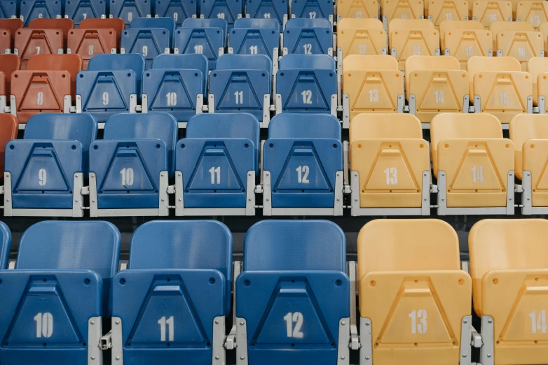 two rows of blue and yellow stadium seats