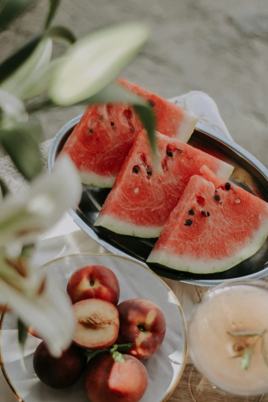 a table filled with sliced up watermelon and other fruit