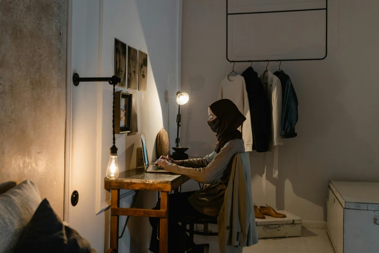 a person sits at a desk working on a computer