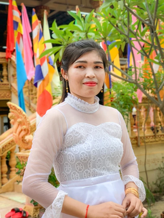 a woman is posing with a red lip