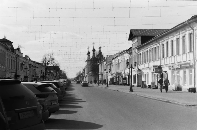 a very narrow city street filled with cars