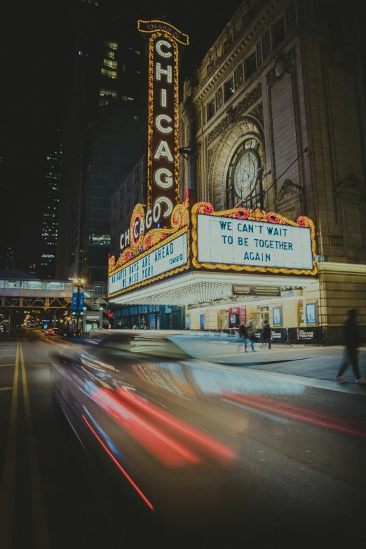 traffic moves along in front of a sign at chicago