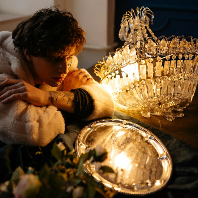 a young person looks sad in front of an open candle