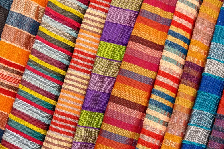 colorful striped fabrics are stacked together