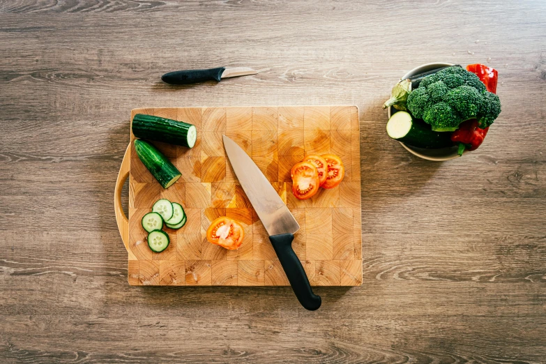 a  board that has several pieces of vegetables on it