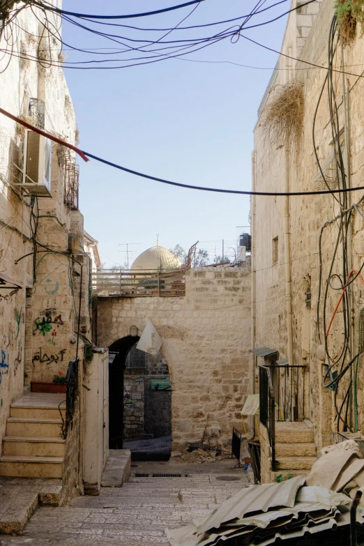 a man walking down an alley way in a small town