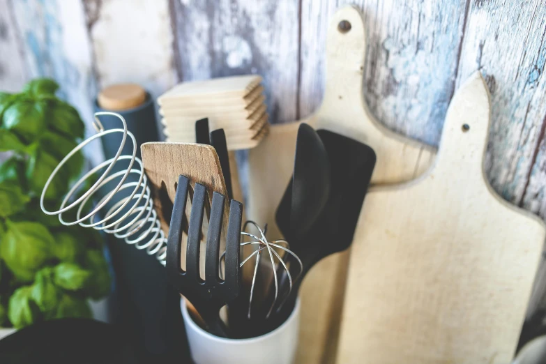 a wooden table with assorted cooking utensils