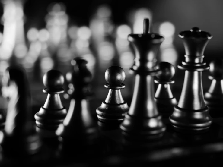 a group of metal chess pieces on top of a table